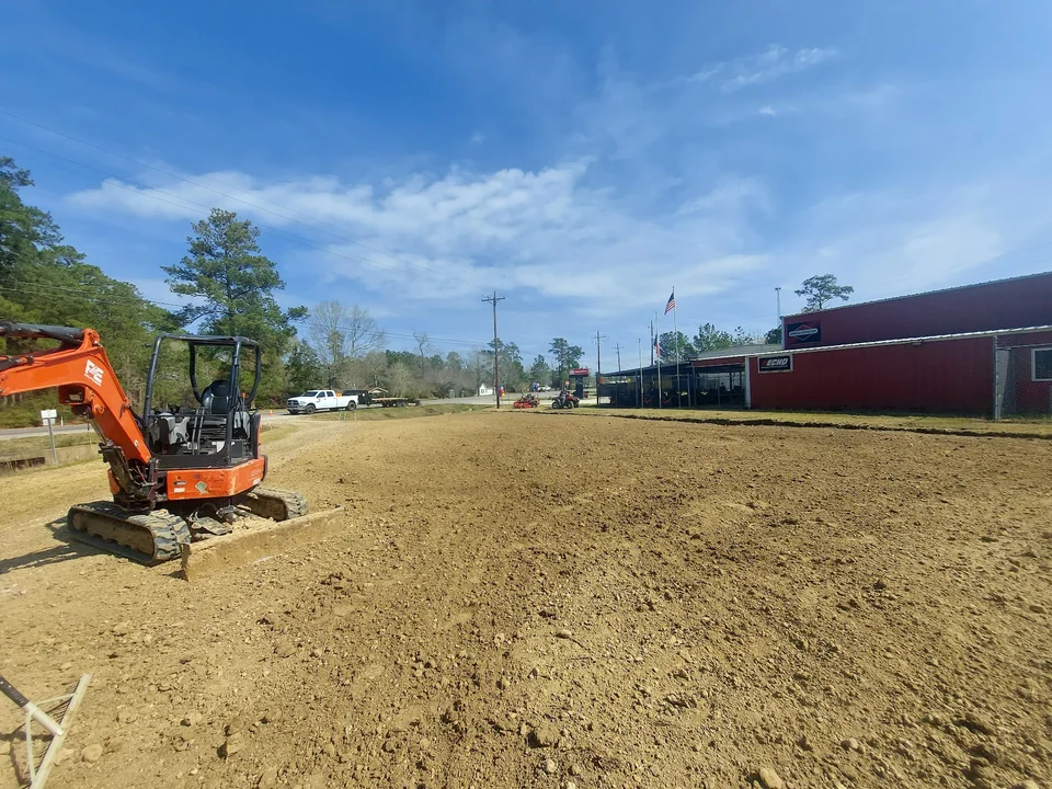 Excavator beside a broad graded work area